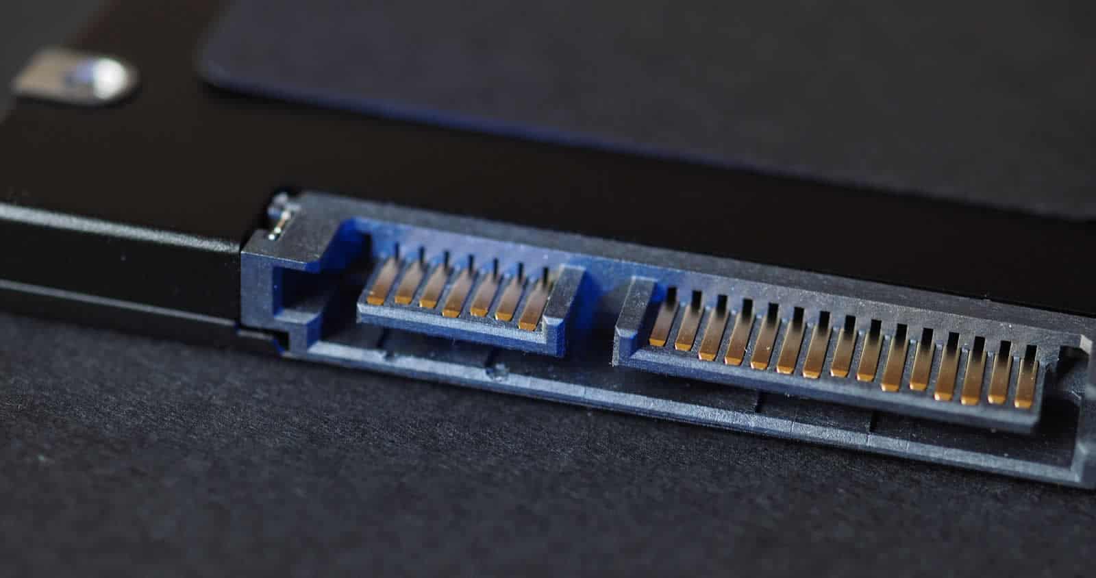 Close-up of the SATA power and data connector on a 2.5-inch solid-state drive.